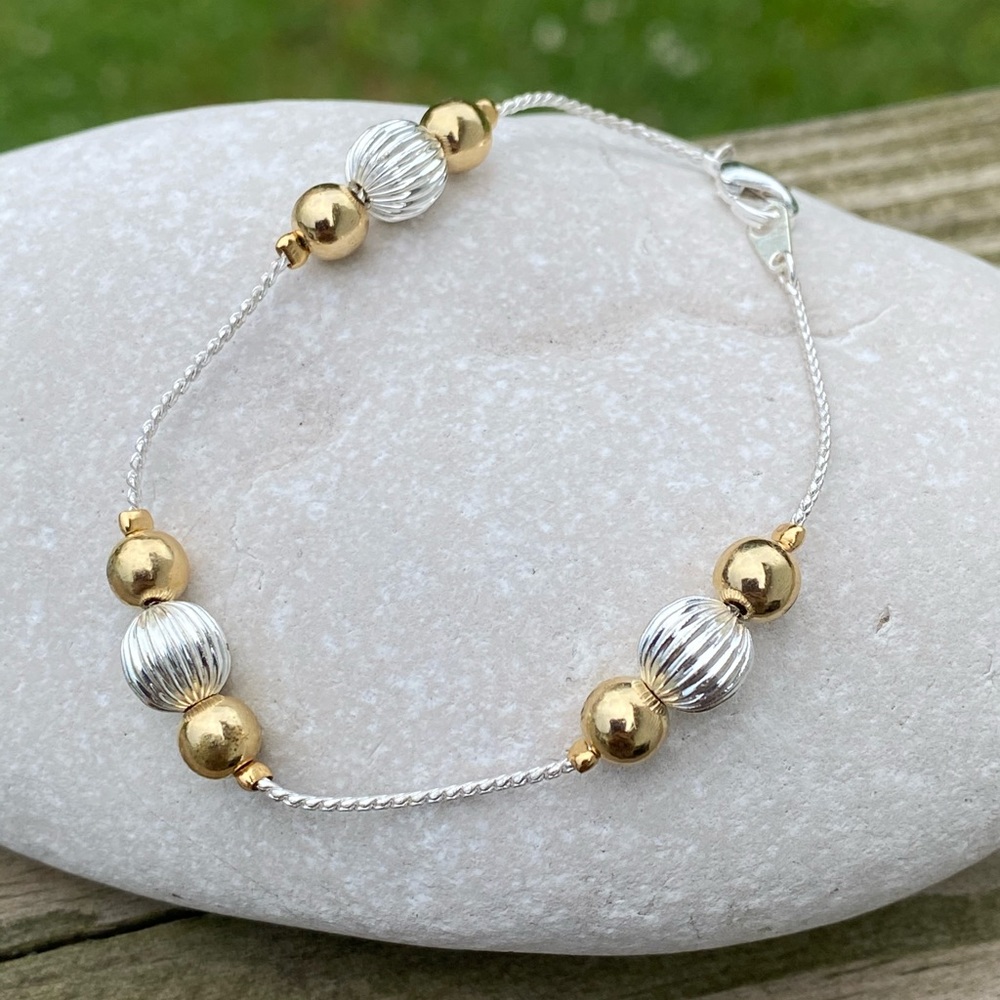 Silver and gold tone ball fashion bracelet